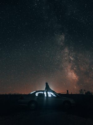 broderie diamant Une personne assise sur une voiture au milieu d'un champ avec des étoiles dans le ciel