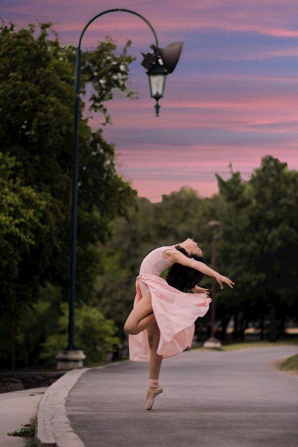 broderie diamant Une femme en robe rose dansant sur un trottoir